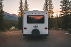 Black and white graphic with mountains and trees and text 'Life is better when you're camping'.