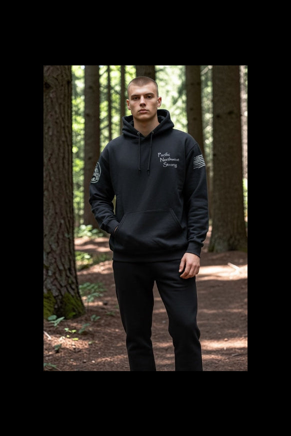 Black hoodie with text and logos in a forest setting